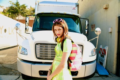 Singer-songwriter Frankie posing in front of a white truck.