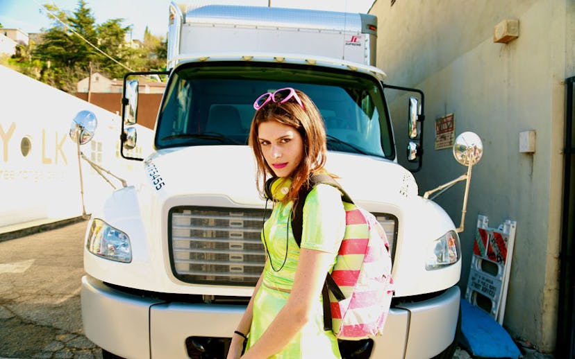 Singer-songwriter Frankie posing in front of a white truck