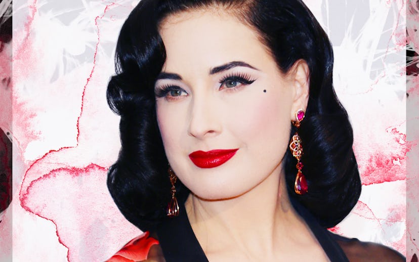 Dita Von Teese wearing a black see-through robe with a red rose pattern