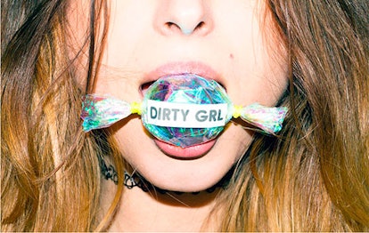 A girl holding a big candy with text "Dirty girl"
