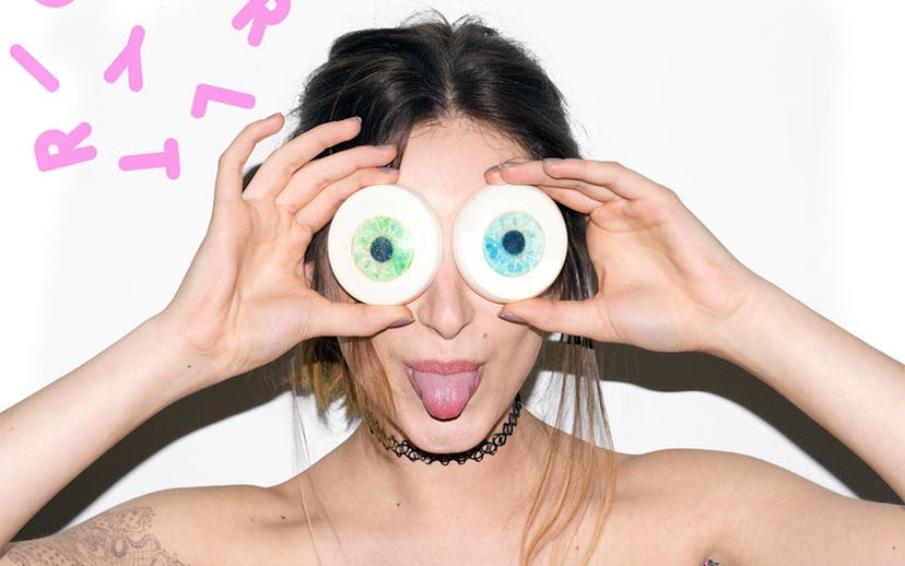 Girl holding up two bars of soap in the shape of eyes