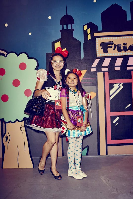 A woman and a little girl posing in Hello Kitty costumes