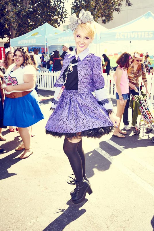 A young girl with blonde hair wearing Hello Kitty-themed clothing