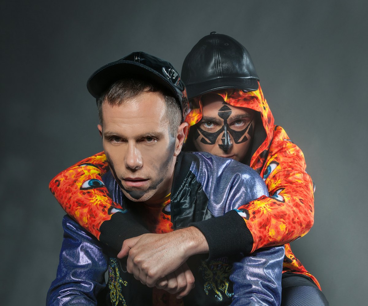 The Presets' Kim Moyes hugging Julian Hamilton from the back while squatting