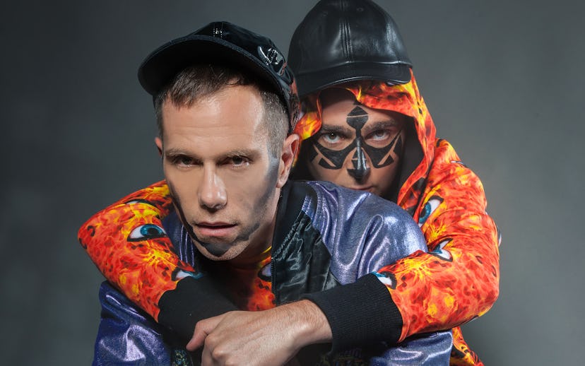 The Presets' Kim Moyes hugging Julian Hamilton from the back while squatting