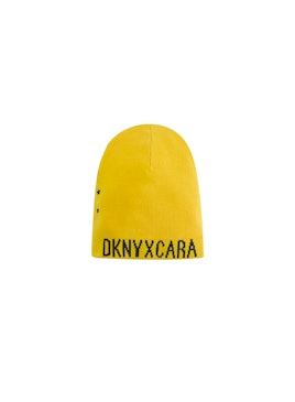 Yellow beanie from the Cara Delevingne's DKNY capsule collection with text on it "DKNYXCARA"