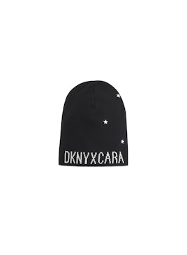 Black beanie with white stars from the Cara Delevingne's DKNY capsule collection with text on it "DK...