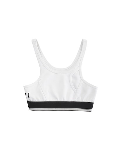 White sports bra with a black line from the Cara Delevingne's capsule collection