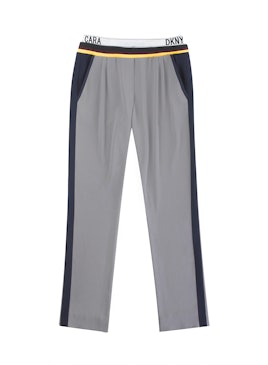 Lower part of gray track suit with black and yellow lines from the Cara Delevingne's DKNY capsule co...