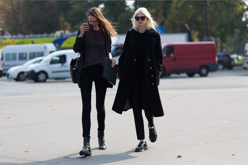 Two street style and all-black dressed girls walking