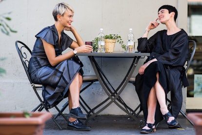 Two models sitting at a cafe by photographer Michael Dumler