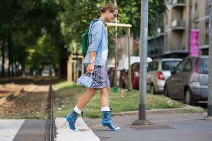 Darla Shapovalova crossing Tram tracks wearing high heels by pohotographer Michael Dumler