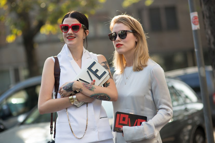 Marianne Theodorsen and Annabel Rosendahl accentuating red colors in their outfits by photographer M...