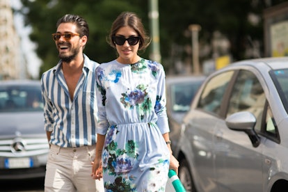 Patricia Manfield and Giotto Calendoli holding hands next to some cars by photographer Michael Dumle...