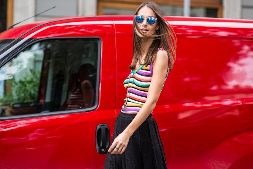 Woman wearing a striped multicolor tank top and blue sunglasses