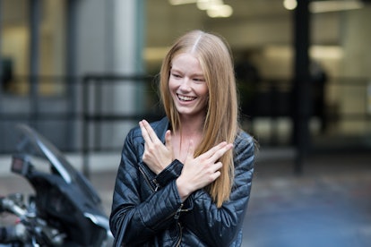 Hollie May Saker smiling in a black leather jacket