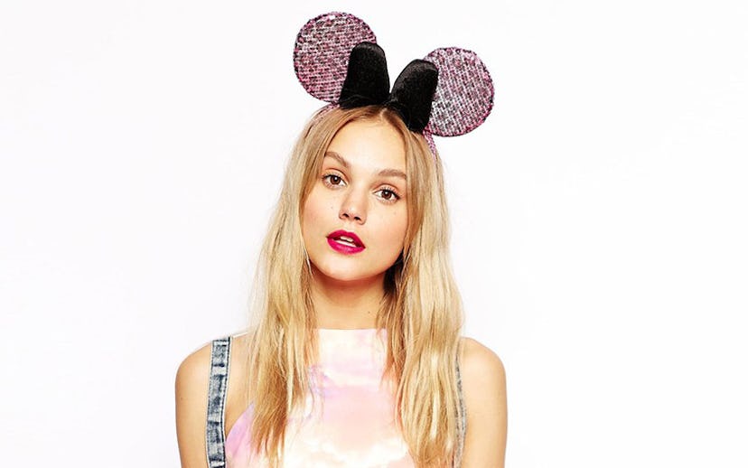 A blonde woman wearing a black and pink leopard print Minnie Mouse headband from ASOS' new collabora...