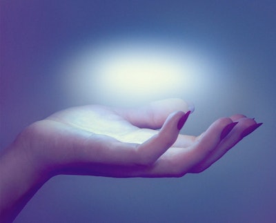 A hand with red nails holding an floating orb of light on the palm with a heavy blue filter in the c...