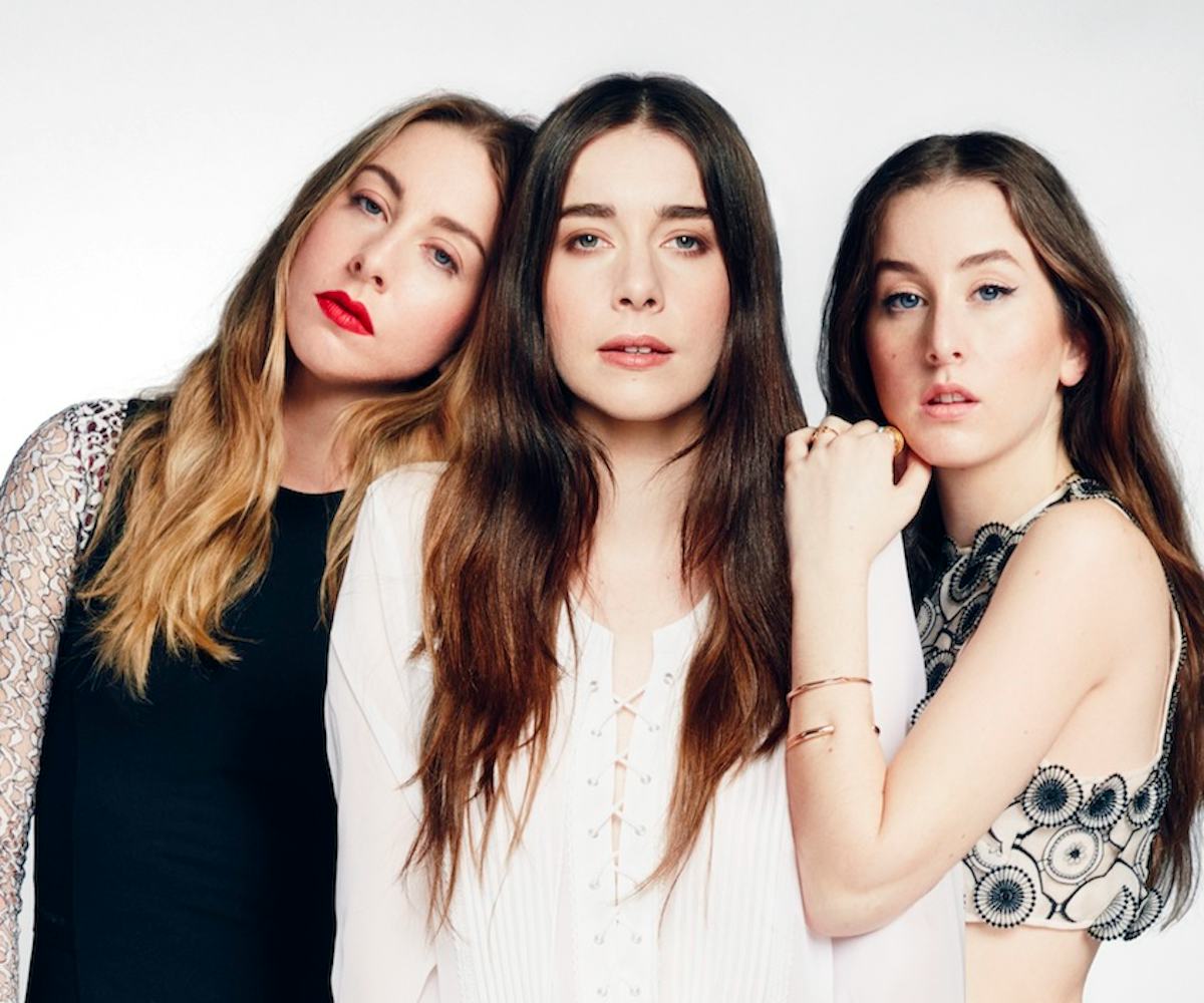 Three Haim sisters posing for a photo