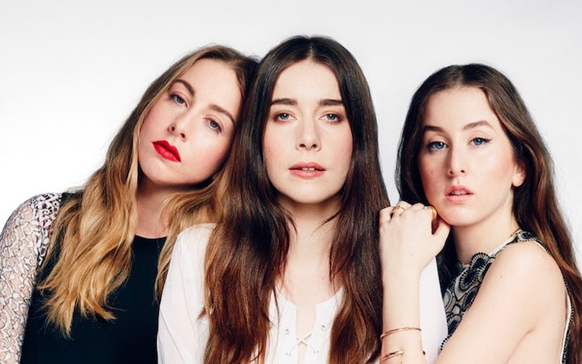 Three Haim sisters posing for a photo