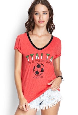 Model posing in denim shorts and in a red t-shirt with the "Italia" soccer logo