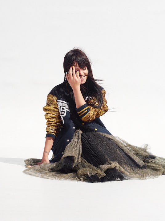 Lily Allen sitting on the floor and smiling in a jacket by Ashish, a dress by Marc by Marc Jacobs an...