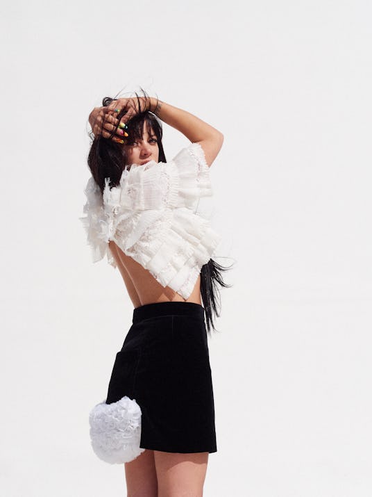 Lily Allen in a white ruffled shirt by Chanel and a black skirt with a white pocket by Vivienne West...