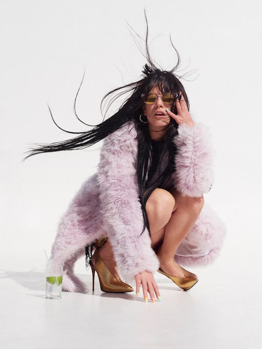 Lily Allen in crouching on the floor in a pink jacket by Calvin Klein, golden Giuseppe Zanotti shoes...