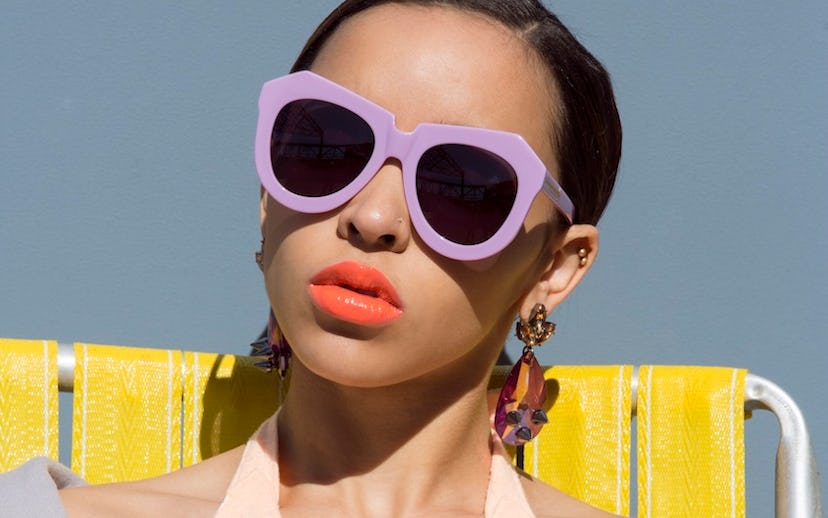 Tinashe wearing a peach colored top with purple glasses