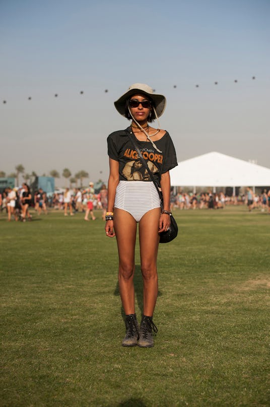 A woman in an Alice Cooper grey-orange shirt, white bikini shorts, beige hat, black sunglasses, and ...