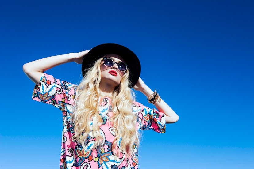 Blonde model wearing an Innra Paisley Print Shift Dress and a hat