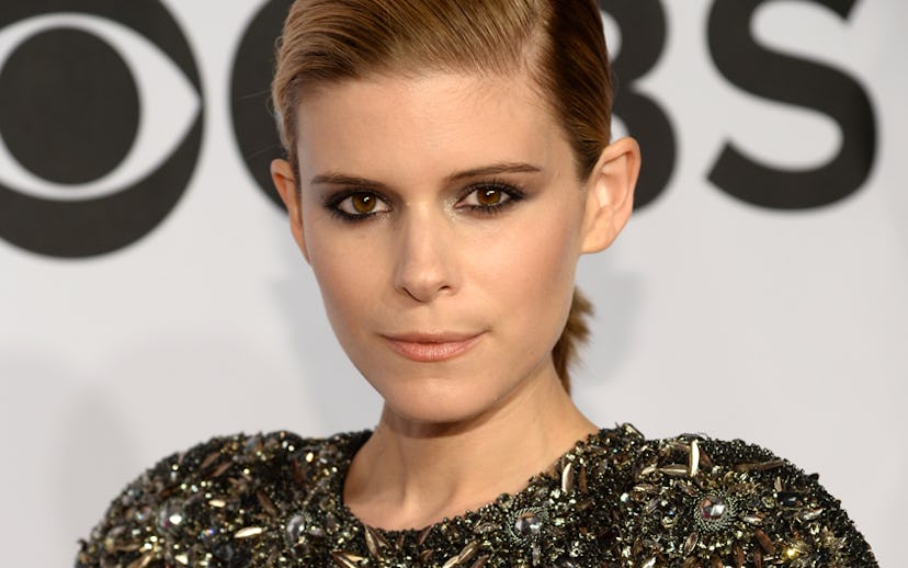 Kate Mara posing while having a low ponytail with a side part