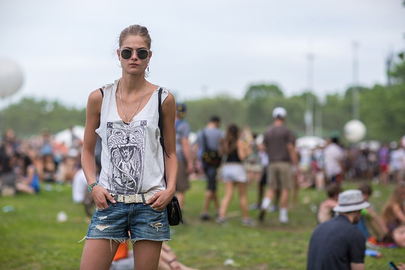 Bo Don in denim jeans, a white tank top and sunglasses with an up-do at Governors Ball