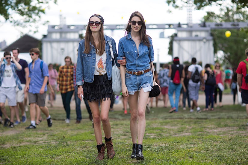 Kelsey Warman in a black fringe skirt, white shirt and denim jacket walking with another woman at Go...