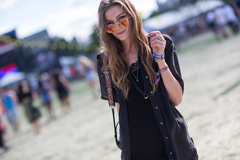 Leslie Kirchoff in a black dress, dark grey jacket and orange sunglasses at Governors Ball 
