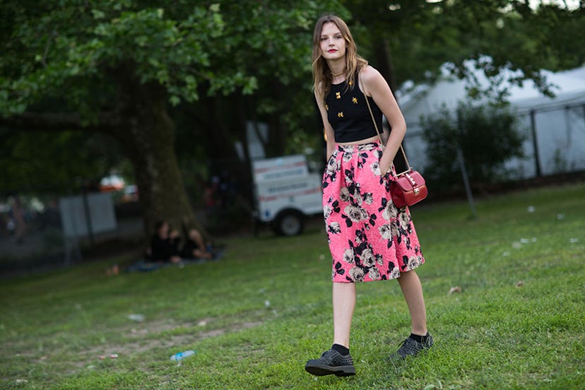 Sara Blomqvist in a black tank top and a pink floral skirt at Governors Ball
