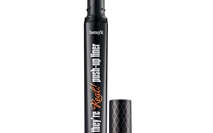 A black tube of the black Benefit push-up liner next to it's lid