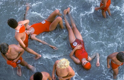 People in red swimsuits enjoying their time on the beach