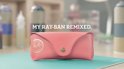 Pink Ray-Ban closed sunglasses case lying on a blue surface with text above it "My Ray-Ban remixed."