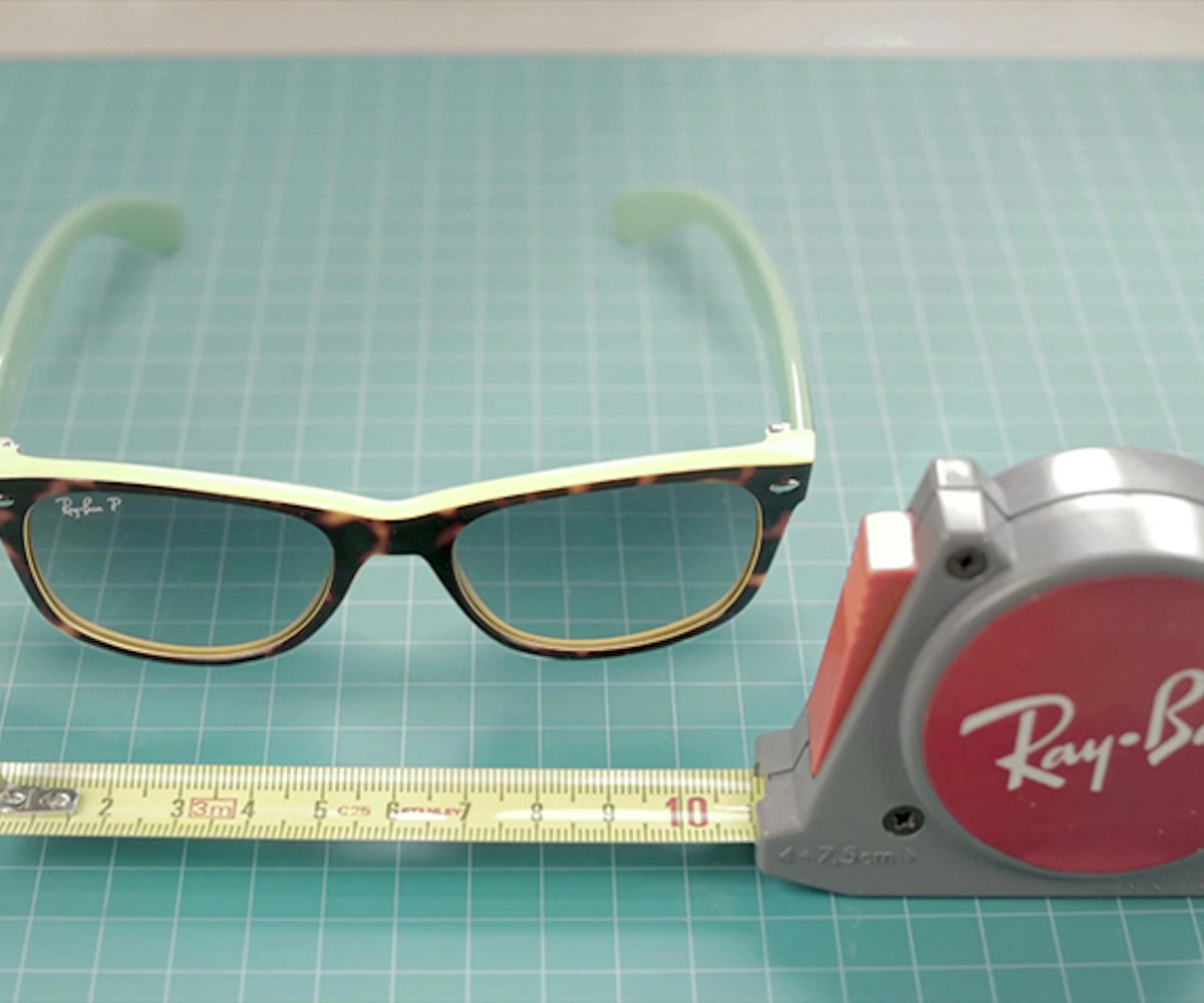 Ray-Ban sunglasses lying next to a red Ray-Ban ruler