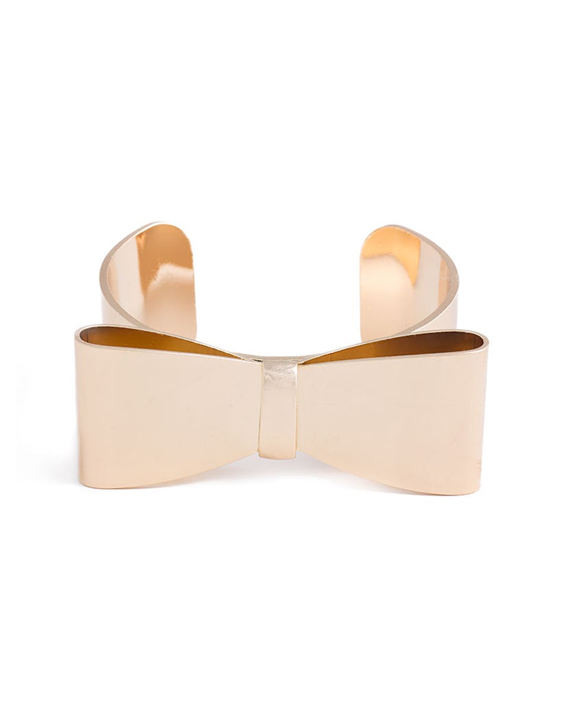 A gold headband with a bow on top