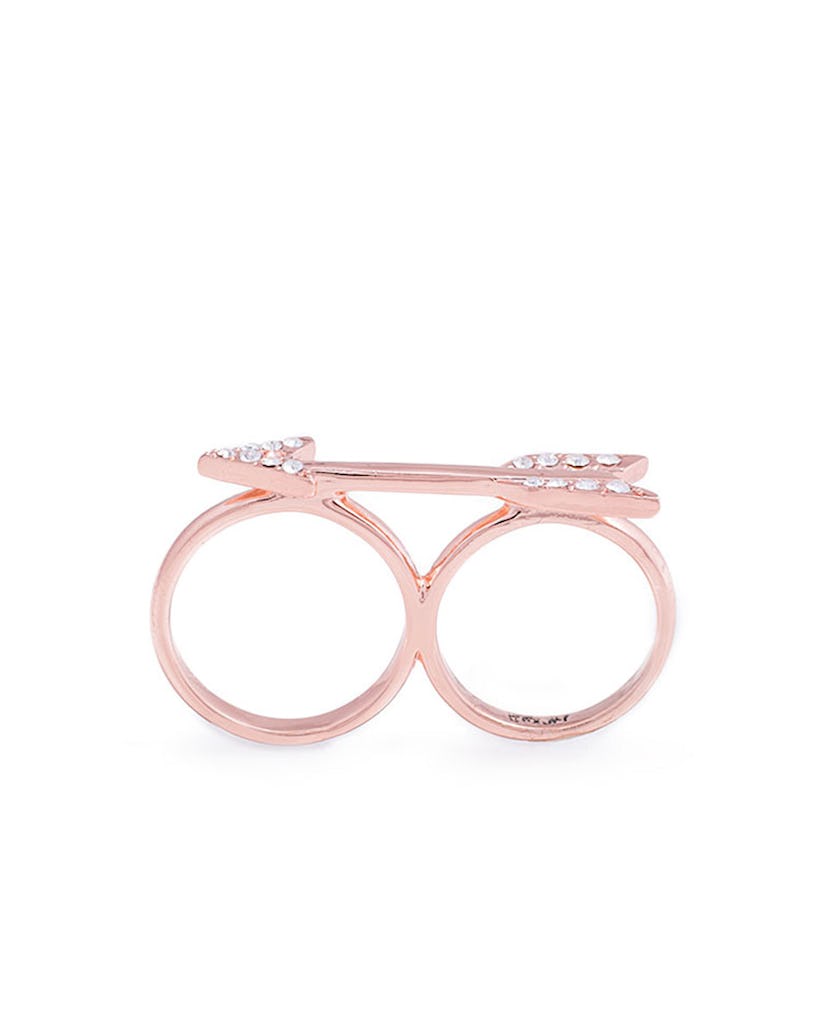 Light pink ring with double space for fingers with an arrow and zircons on top