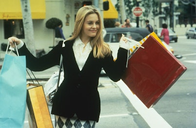 Alicia Silverstone as Cher in the movie Clueless with many shopping bags