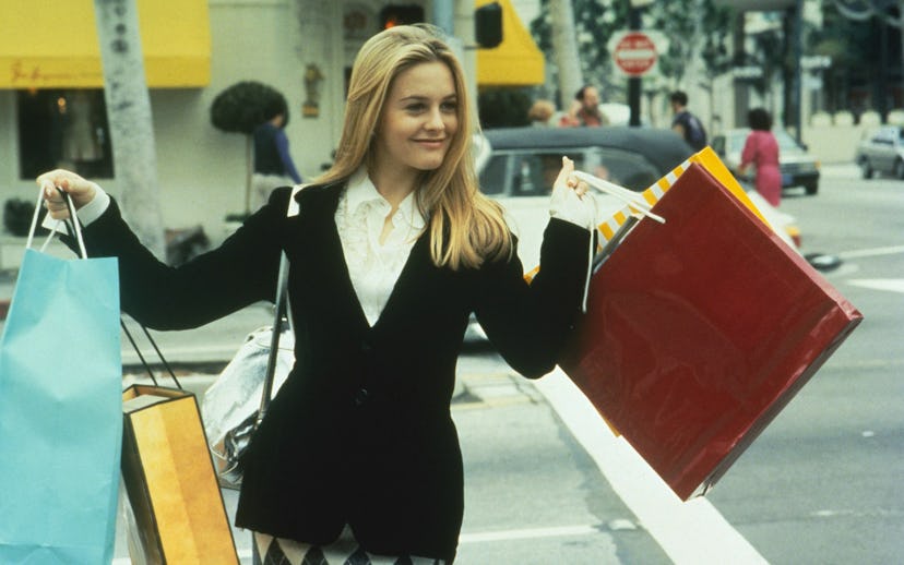 Alicia Silverstone as Cher in the movie Clueless with many shopping bags