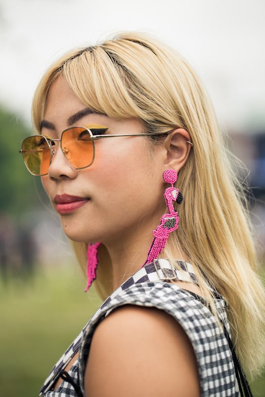  Blond girl wearing orange sunglasses and a black and white checkered dress