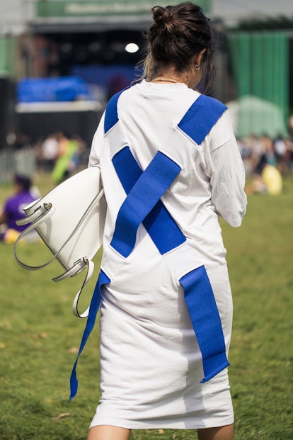 Woman wearing a white dress with a blue cross on the back 