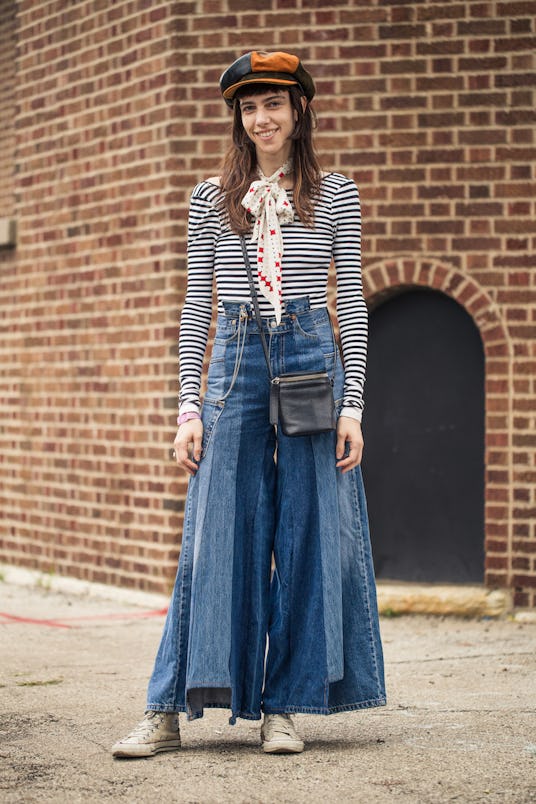 A girl in an off-shoulder striped long-sleeved shirt, beret, silk scarf and flared jeans