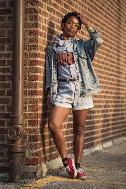 Girl in a denim coat and denim shorts with a gray hoodie