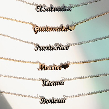 Hija de tu Madre necklaces with names of different countries on them 