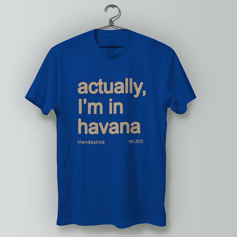 A blue Clandestina t-shirt with "actually I'm in havana" on it 